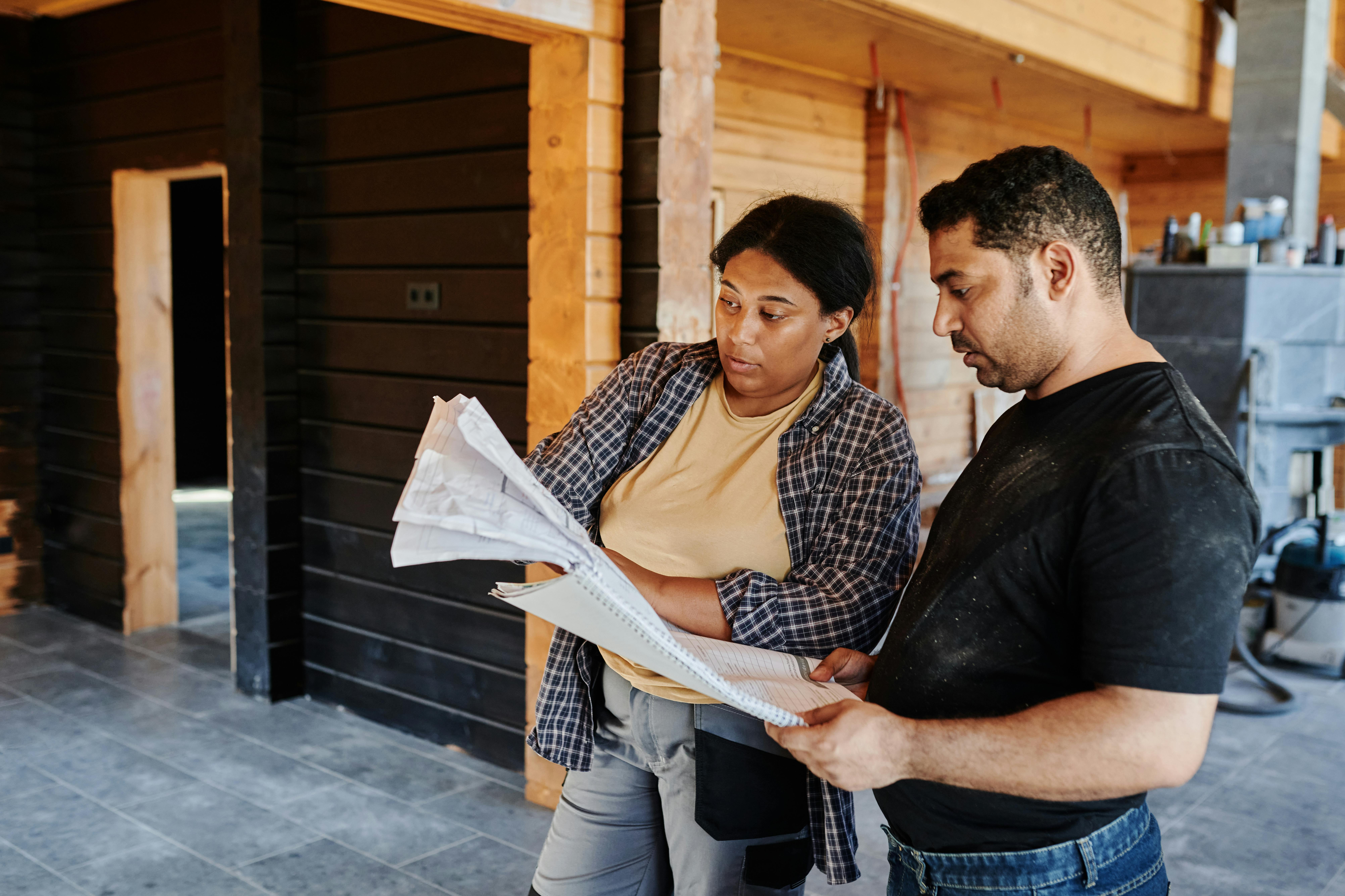 Contractor reviewing plans with a client on site